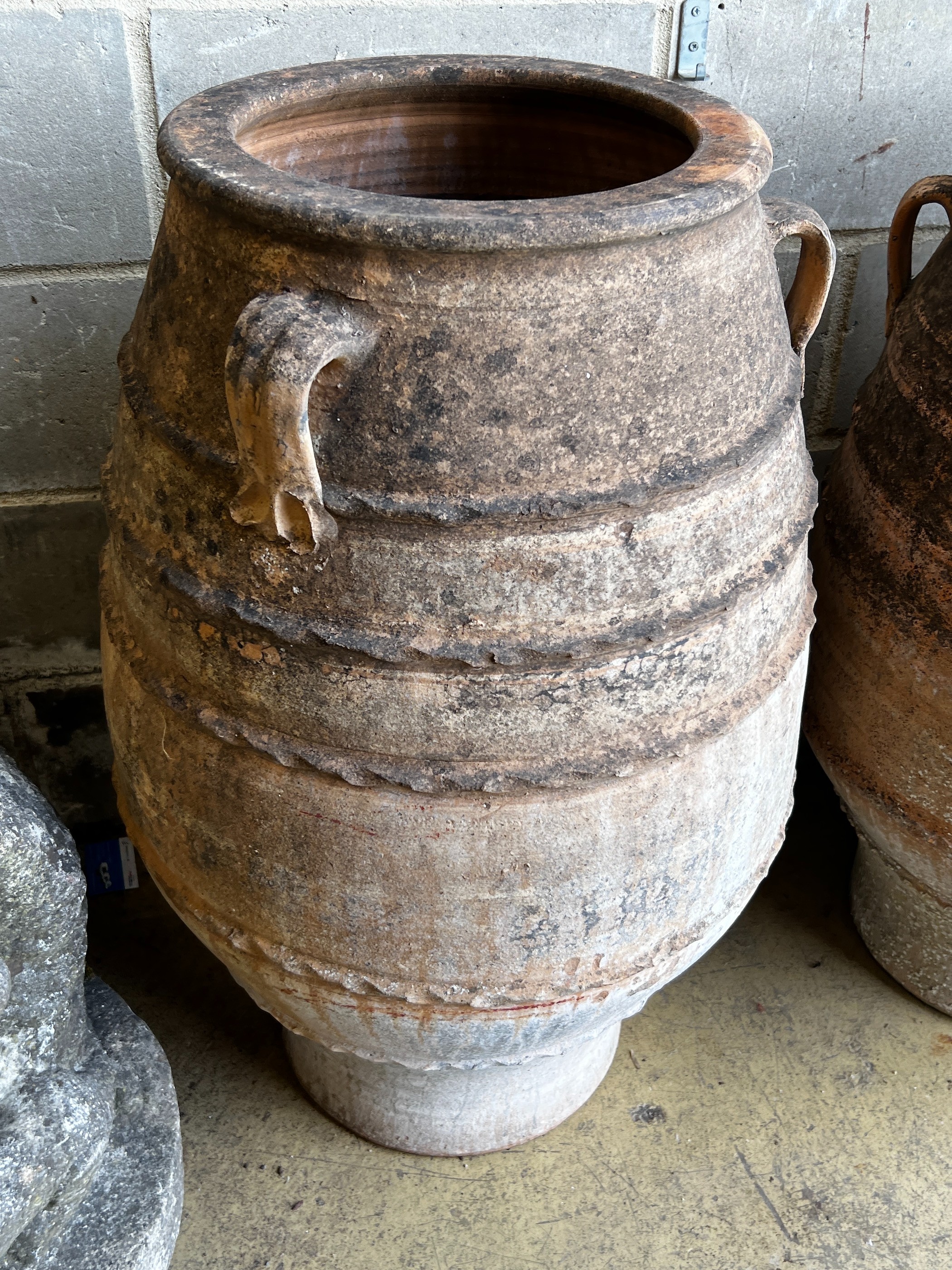 Three Greek terracotta oil jars, largest height 91cm